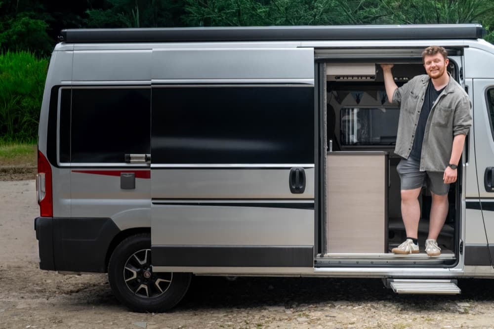 Owner standing in the doorway of his campervan
