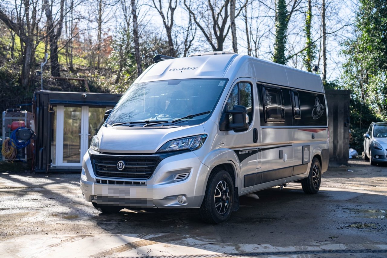 A freshly cleaned Hobby motorhome photographed in bright daylight, ready to be advertised for sale