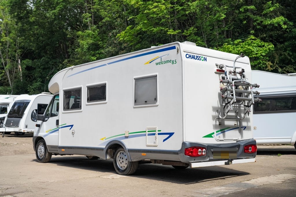Rear three-quarter view of the Chausson Welcome 85 showing the fitted bike rack and rear bumper (number plate digitally obscured)