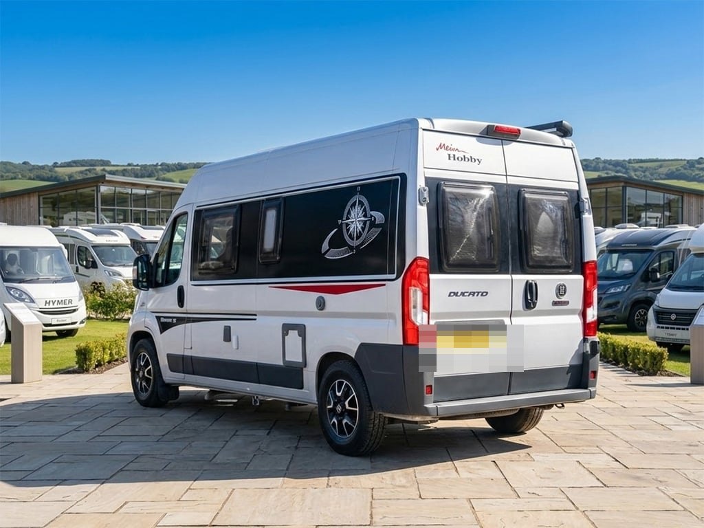 Rear three-quarter view of the silver Hobby Vantana K60 with 'Mein Hobby' and 'Ducato' badging, parked on the Halifax forecourt (number plate digitally obscured)