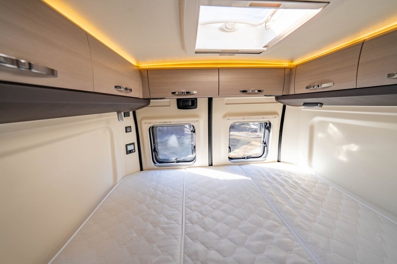 The Hobby Vantana's rear lounge made up into a bed with mood lighting