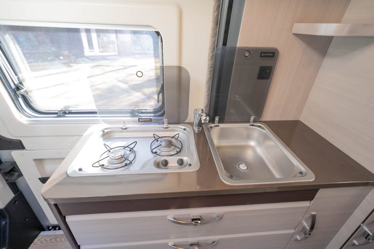 The Hobby Vantana's mid-van kitchen with a gas hob, sink and a rooflight above