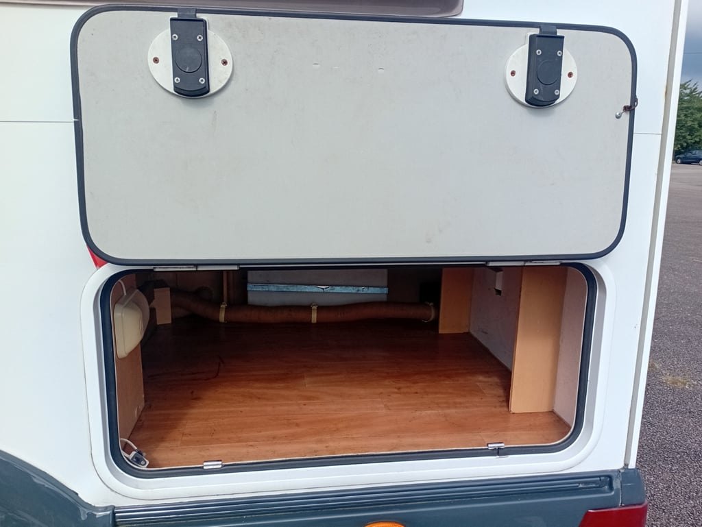 The external locker of the Auto-Roller 15 open, showing the carpeted storage space inside