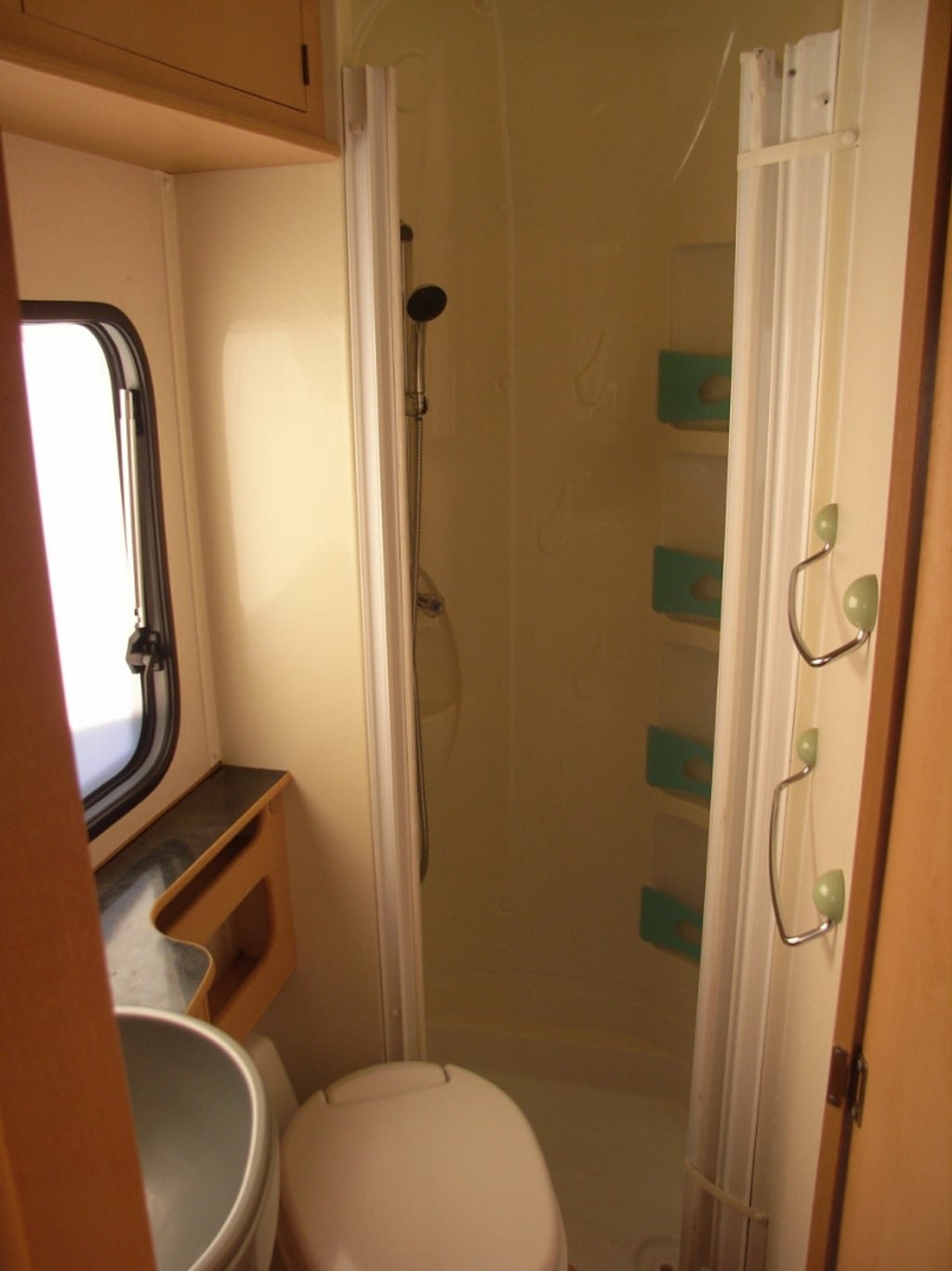 The washroom of the Auto-Roller 15 with the toilet and a window