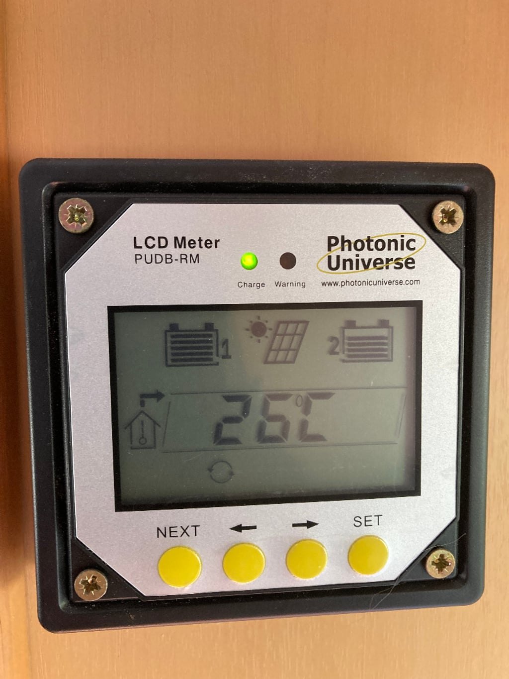 A wall-mounted solar charge controller display inside the Auto-Roller 15 showing a reading