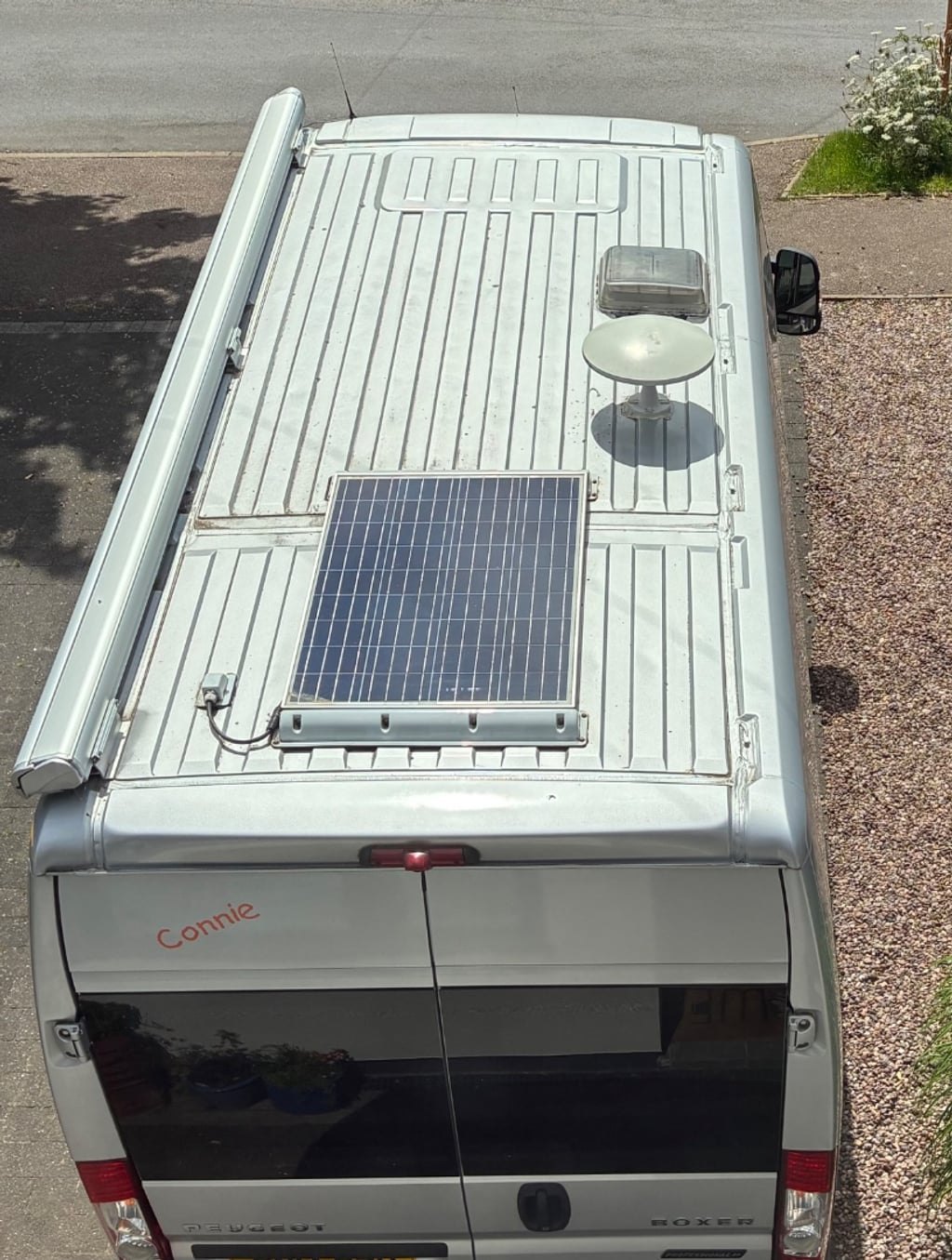 The roof of the campervan seen from above, showing the 100W solar panel mounted on the white roof